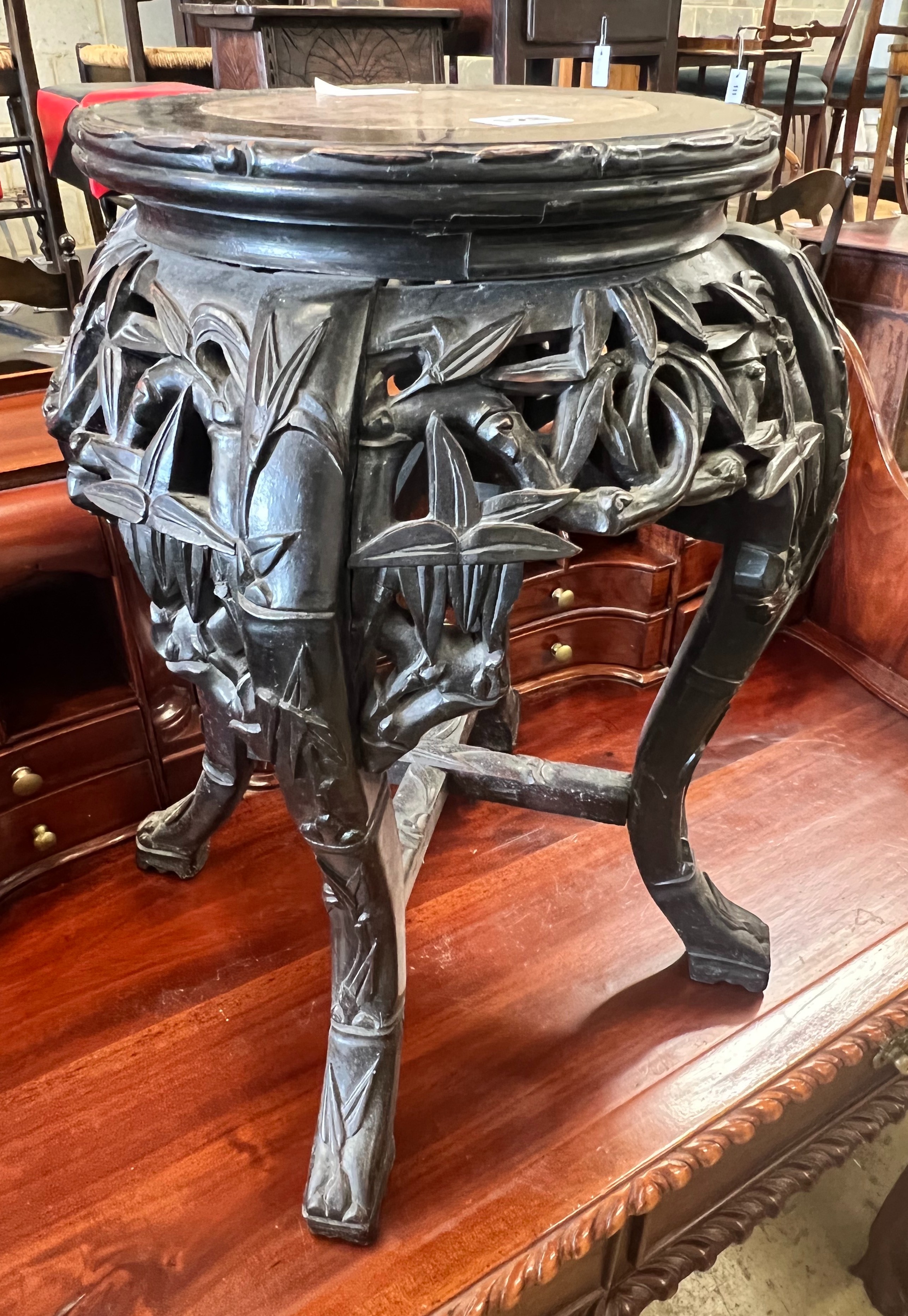 A Chinese carved hardwood circular marble topped vase stand, width 32cm height 47cm